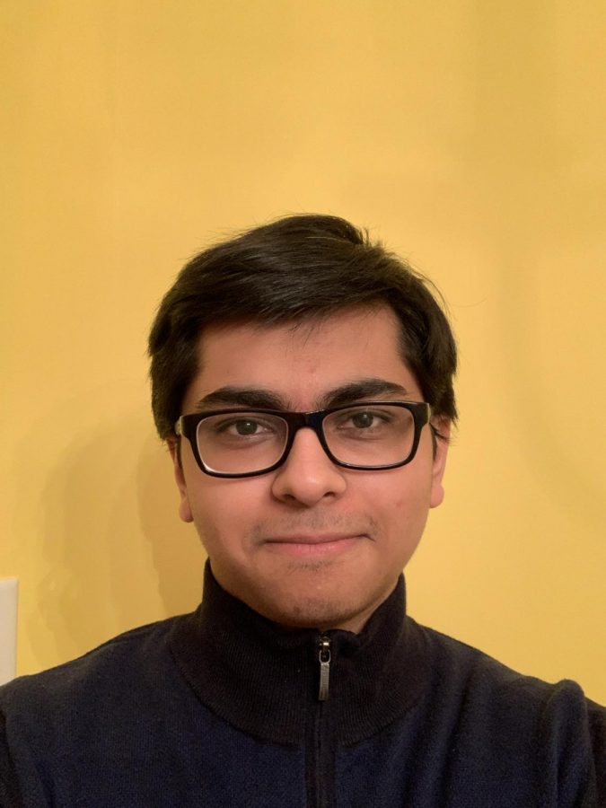 Junior Ronojoy Dutta, the web developer for the club, poses for a selfie in his living room.