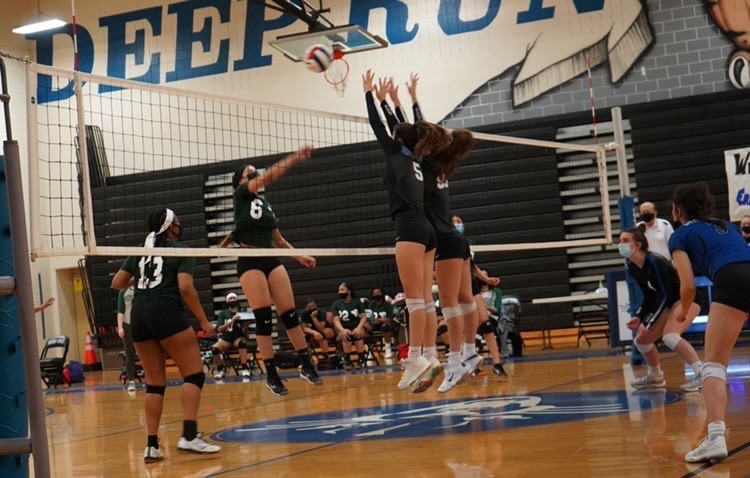 The girls volleyball team competes.