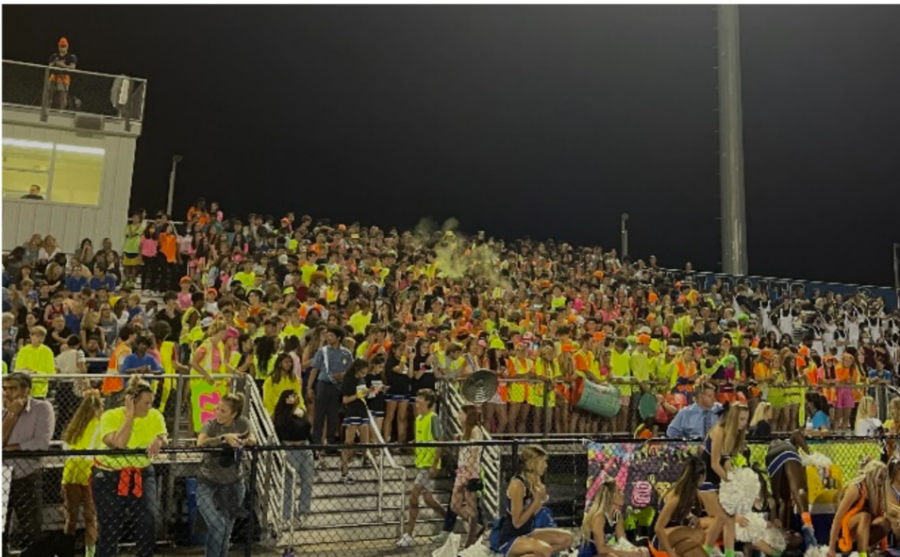 Students+dressed+in+neon+pack+the+student+section+at+the+Deep+Run+homecoming+football+game+versus+Godwin.