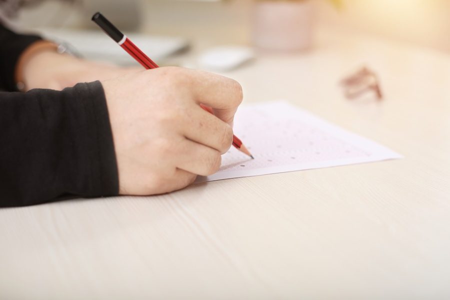 Test taker completes the paper version of a standardized test. (Photo sourced from pixabay.com)