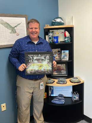This is Dr. Fellows standing next to his Eagles Shrine in the Deep Run Main Office. 
