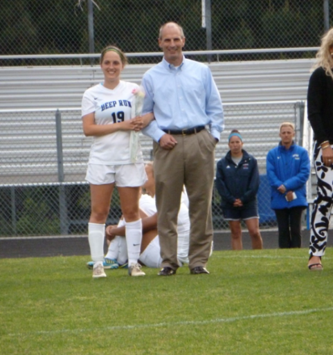 Jessica Renehan, walks on the field with her father Jim Renehan, on the girls soccer teams senior night in 2013.

