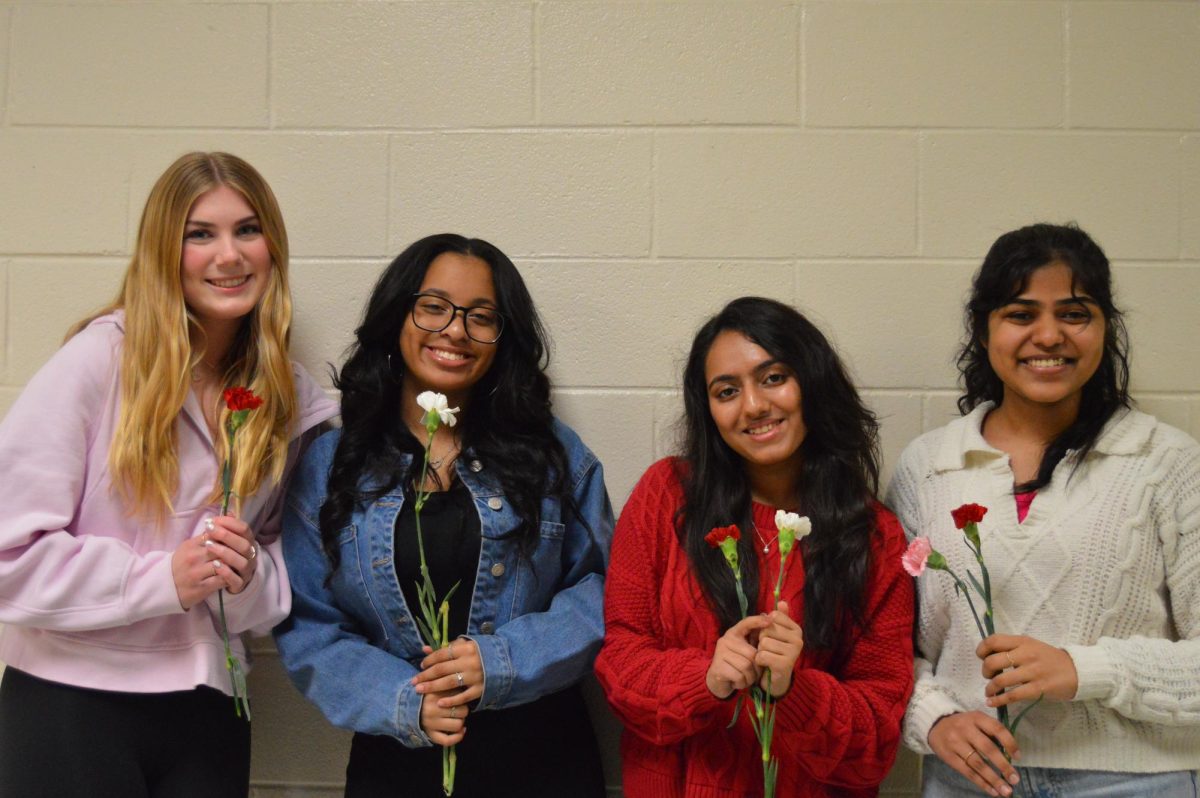 Juniors+Brooklyn+Roever%2C+Kennedy+Reed%2C+Riva+Sarang%2C+and+Meneja+Gautam+pose+together+with+their+flowers.