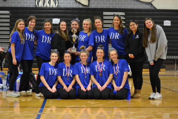 The gymnastics team poses in the gym after their regional win.

