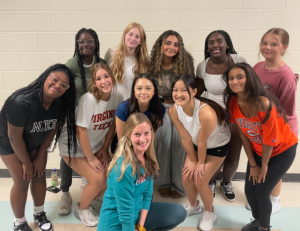 The dance team poses with new coach Moeller (front row).