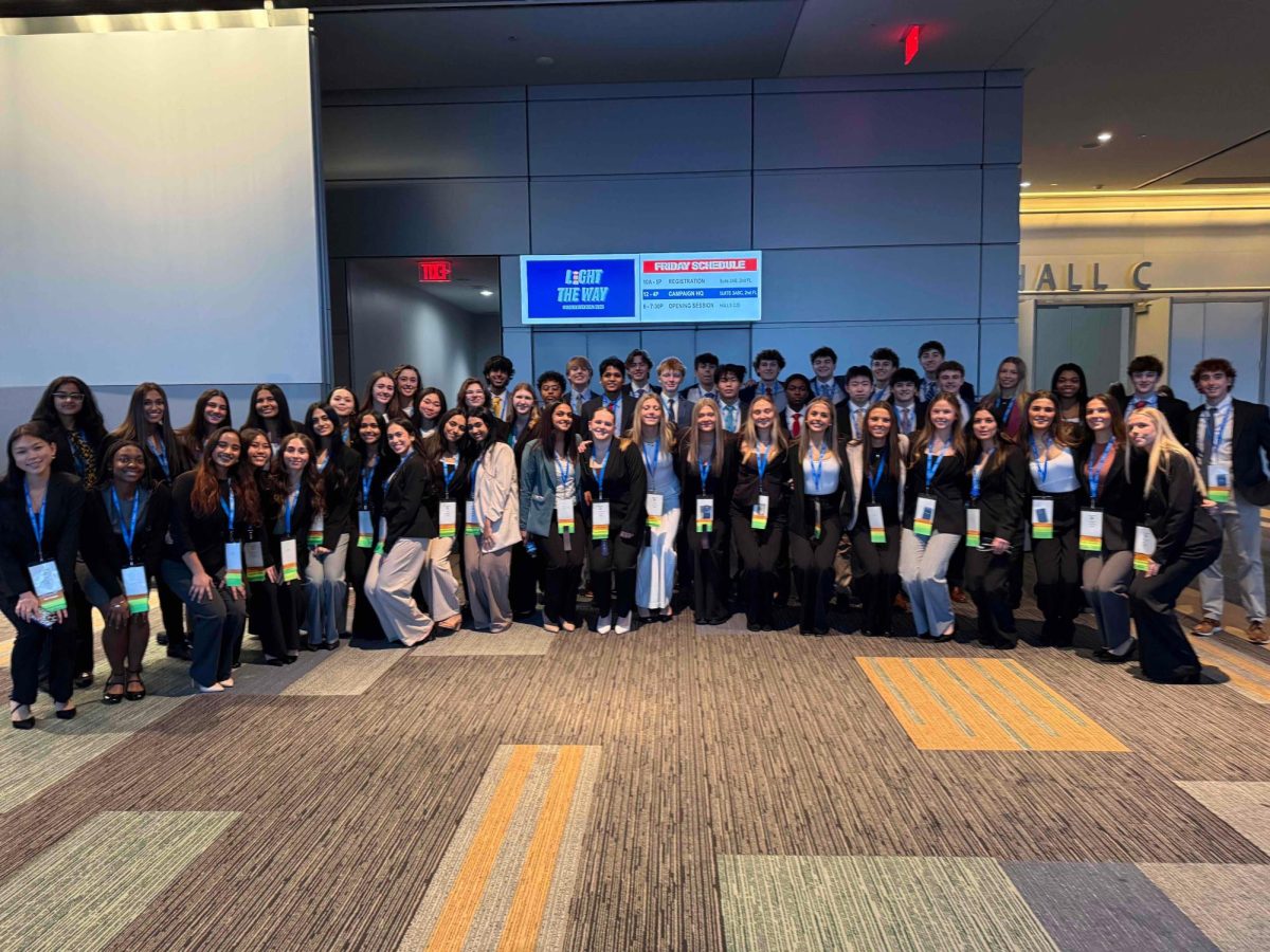 DECA members gather for a group photo at the State Leadership Conference, proudly representing their school in professional attire. 