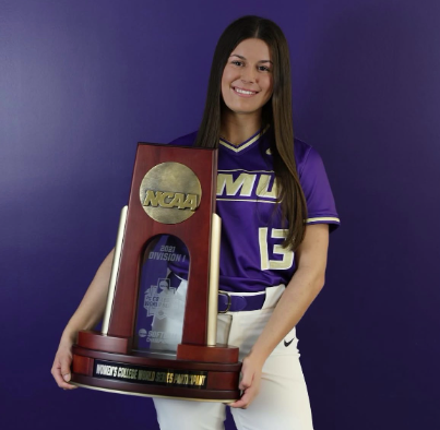 Baulsir proudly holds the NCAA softball trophy.