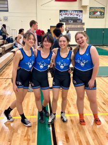 Freja Dodson, Olivia Hyde, Isabella Simon, and Emily Eskins are all smiles after winning their matches against Henrico High School on Dec. 7. 