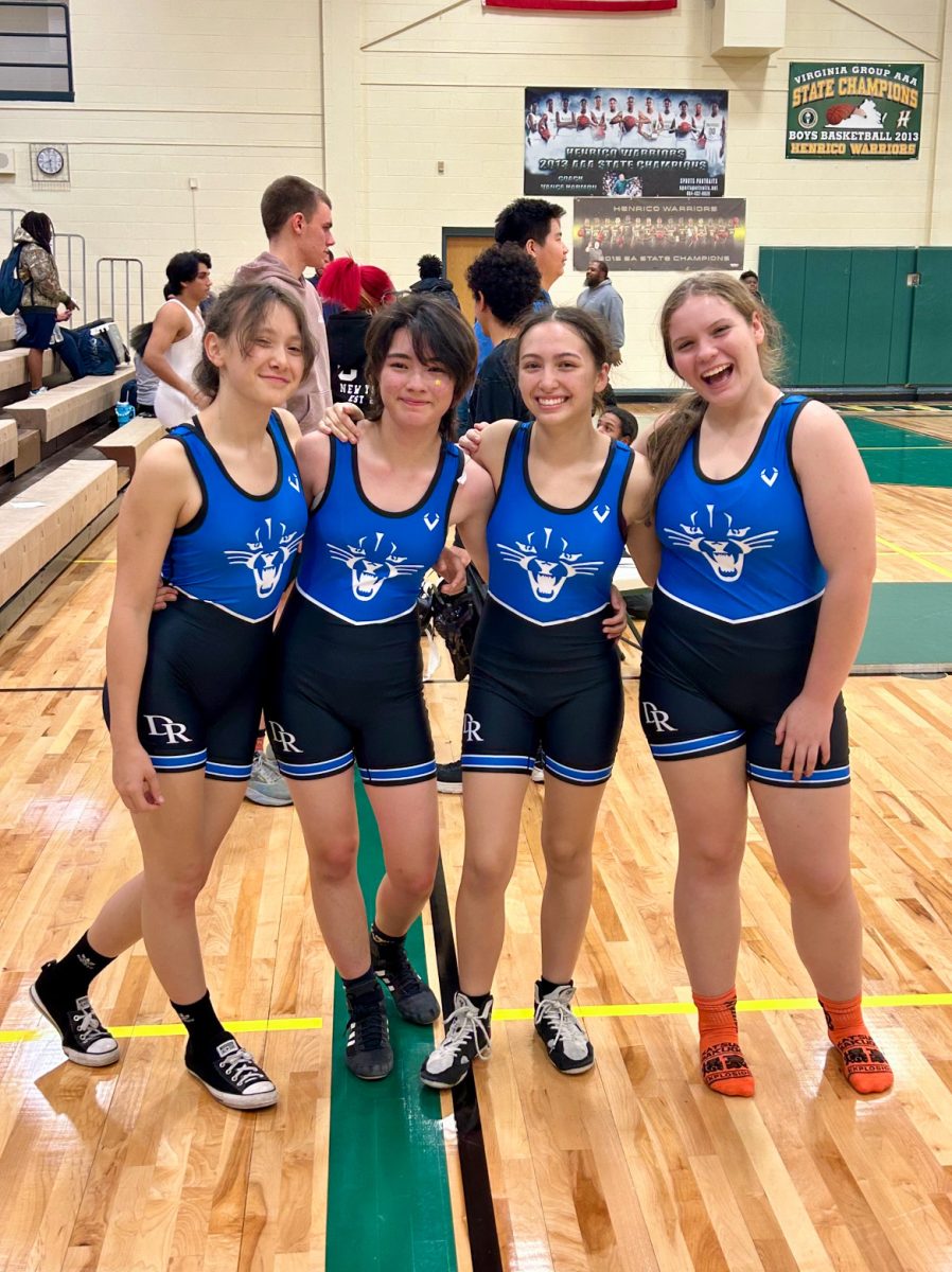 Freja Dodson, Olivia Hyde, Isabella Simon, and Emily Eskins are all smiles after winning their matches against Henrico High School on Dec. 7. 