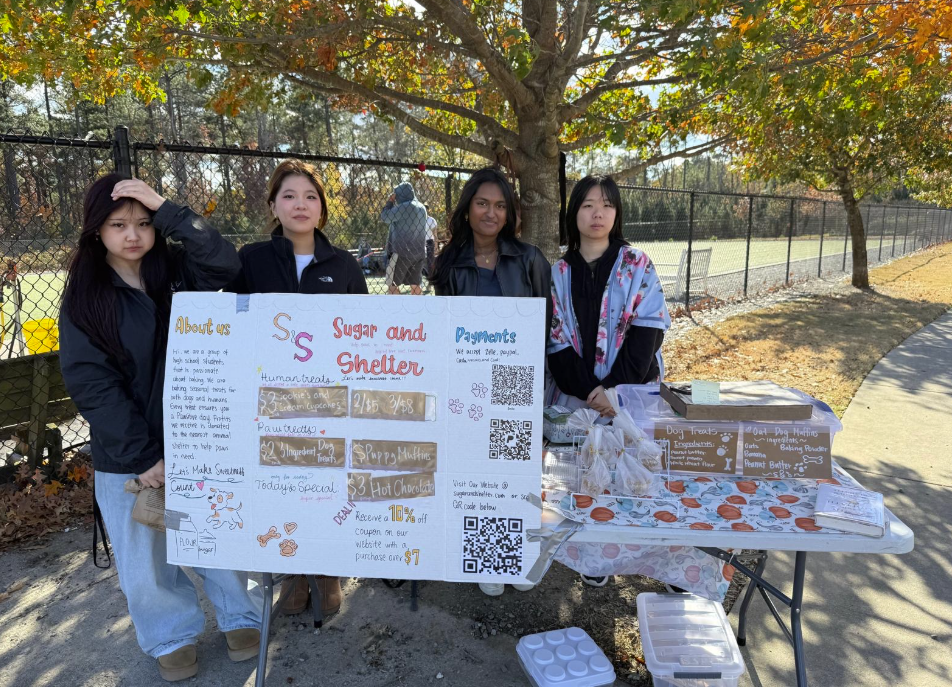 Sugar and Shelter's members host a bake sale at a dog park.