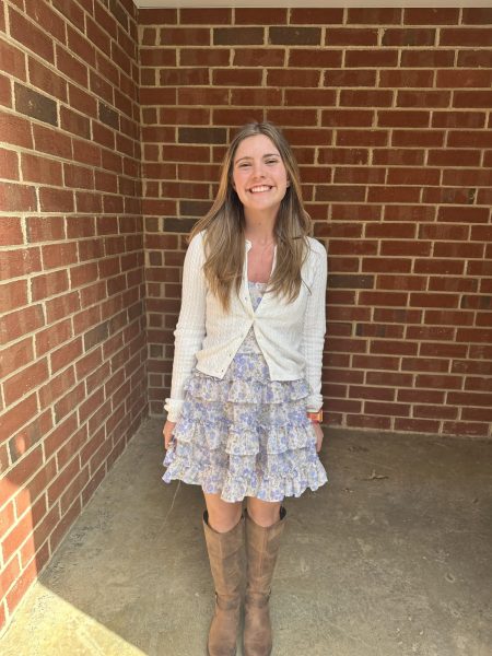 Haggai communicates her welcoming character through her floral dress and bright smile.